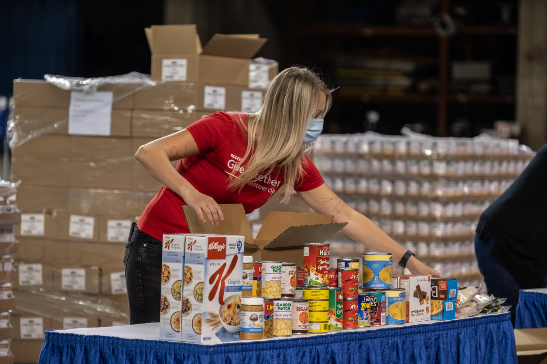 Rogers volunteer packing boxes of food at Rogers Centre