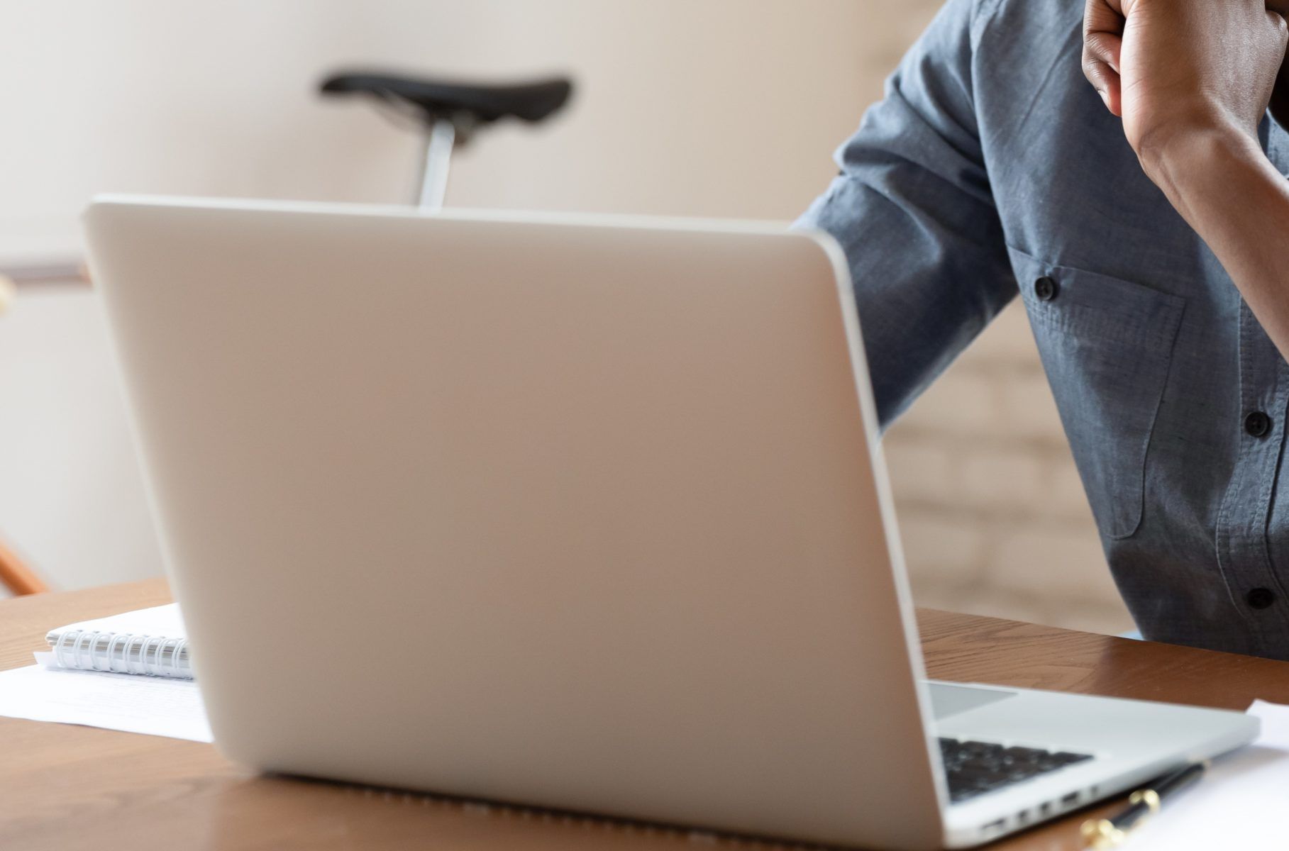 Closeup of adult using laptop at home