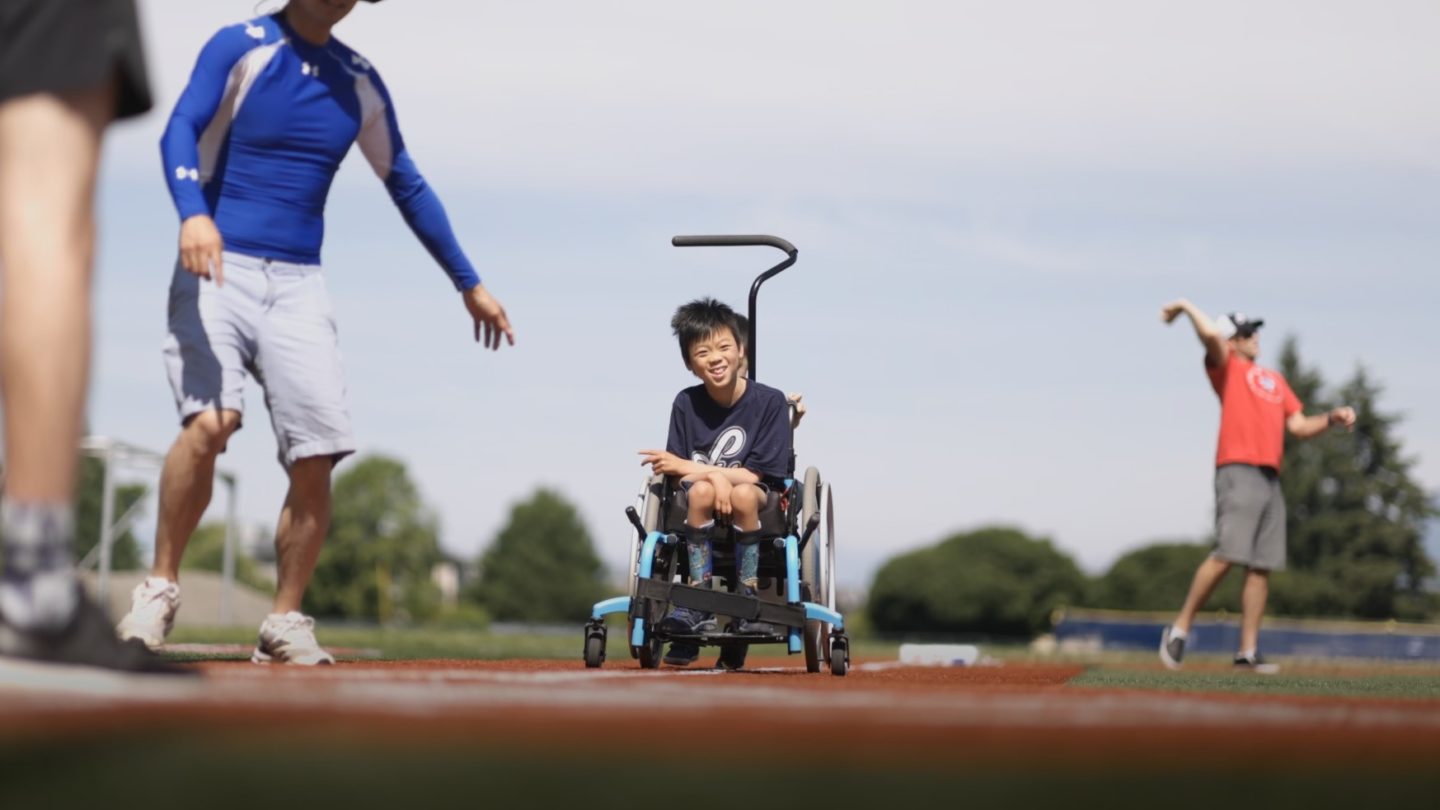 Child in wheelchair on baseball field