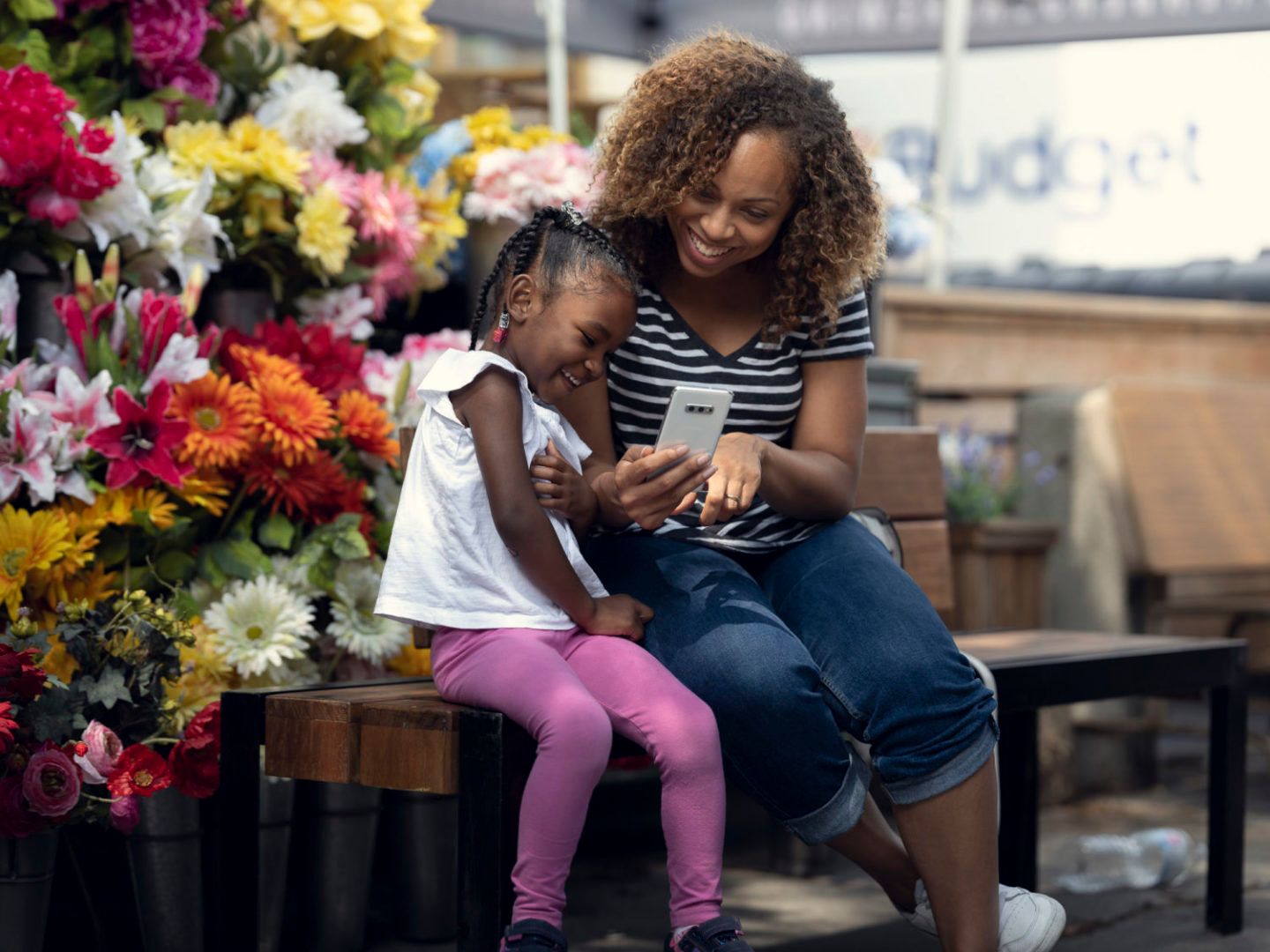 Child and parent on phone in flower shop